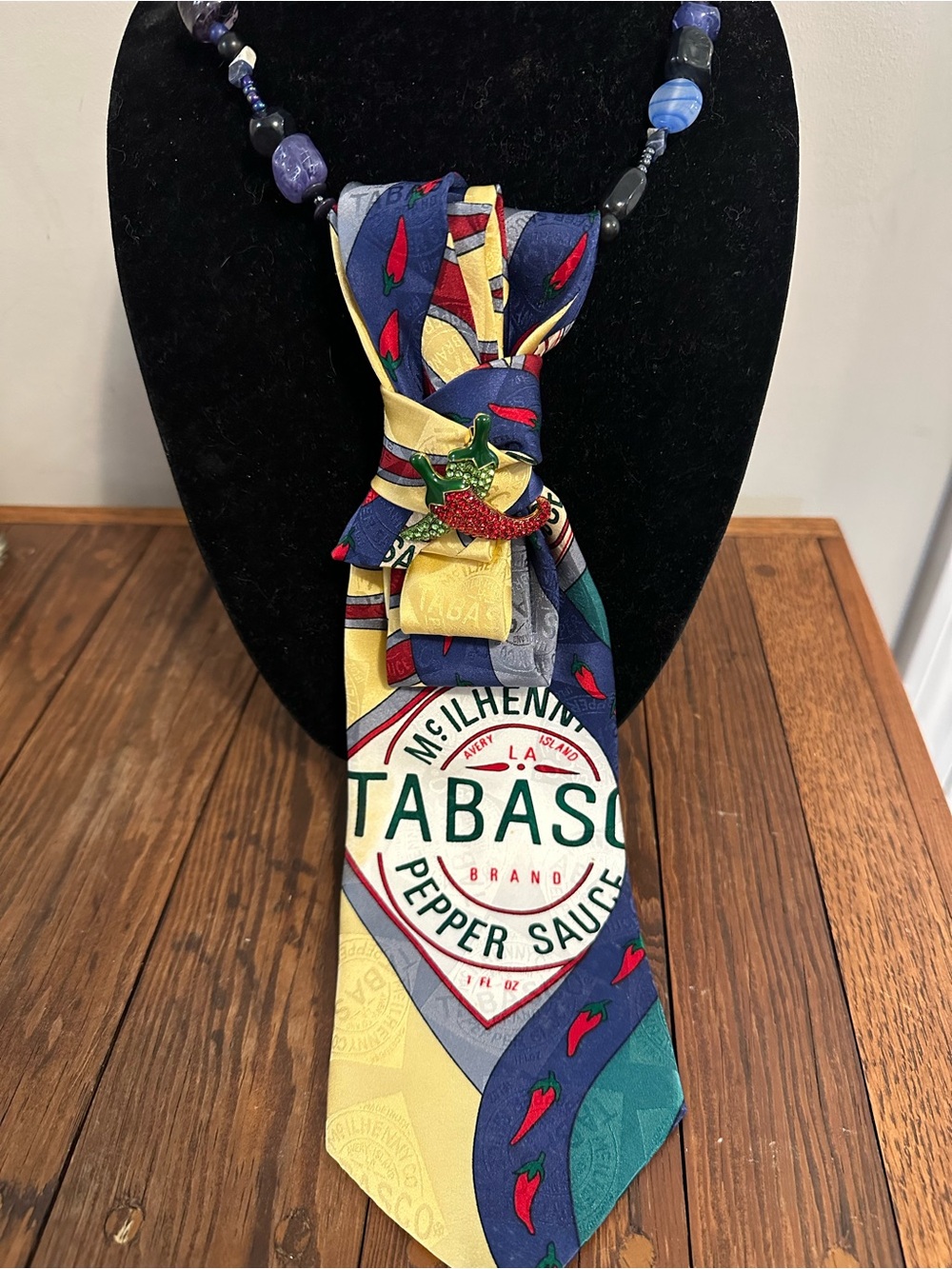 Tabasco Multicolor Silk Novelty Tie neclace with Chili brooch on blue beads.